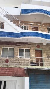 an image of a house with a balcony at Rainbow Guest House in Mahabalipuram