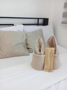 a pair of baskets sitting on top of a bed at AA Cozy Comfort in Nuvali in Calamba