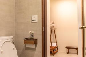 a bathroom with a white toilet at 左鄰右舍 慢旅空間 in Wujie +18 photos