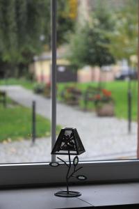 a small black figurine in front of a window at Pod Papugami in Srebrna Góra +18 photos