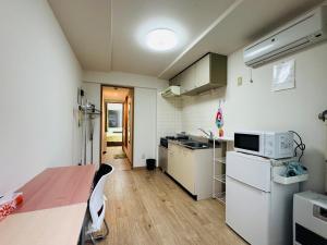 a small kitchen with a table and a microwave at Vivere南5条 in Sapporo