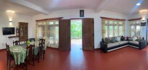 KandyYasasa Spiritual Ayurvedic Villa的客厅里有一张桌子和一张沙发