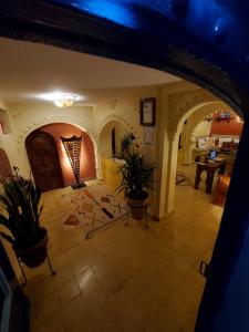 a room with potted plants on the floor in a house at Cactus rooms in Chefchaouen