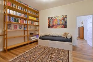 a bedroom with a bed in a room with bookshelves at Residenza La Donzella - Appartamento bianco in Campobasso