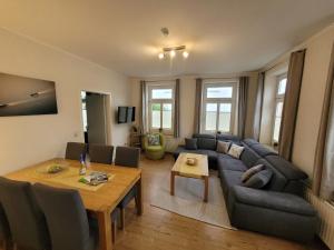 a living room with a couch and a table at Skerra Apartments "am Fitness-Studio" in Fehmarn