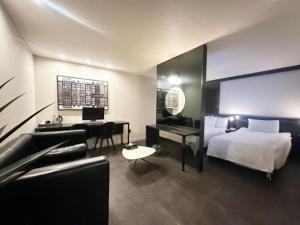 a hotel room with a bed and a desk at Sintra Hotel in Goyang