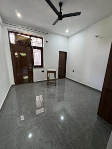 an empty room with a ceiling fan and a table at 2BHK Semifurnished House in Greater Noida
