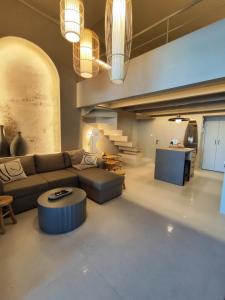 a living room with a couch and a table at Loft 181 by Oikies Rentals in Neoi Epivates