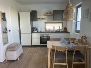 a kitchen with a table and chairs in a room at The best view in Marezige