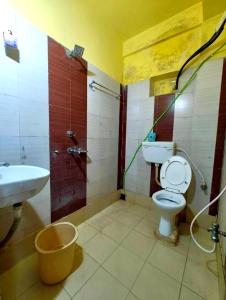 a bathroom with a toilet and a sink and a shower at Hotel Samrat Palace Puri-Odisha Near Sea-Beach With Free Wi-Fi and Parking Facility in Puri +28 photos