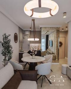 a living room with a table and chairs at Gold Apartment E54 Let's Sea Baltic Park Gąski in Gąski