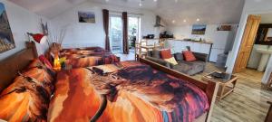 a bedroom with two beds and a living room at Windsor Cottage on The Big "W" Ranch in Nether Wasdale