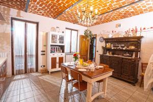 a kitchen with a table and a dining room at B&B Lanterna delle Fate in Asti