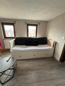 a large couch in a room with two windows at Small House park free at street in Stuttgart