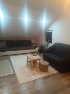 a living room with a couch and a coffee table at Nila in Ivanjica +7 photos