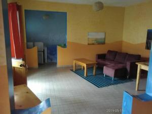a living room with a couch and a table at Djabraba's Double Suite in Garça
