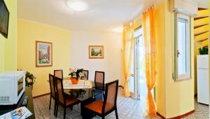 a dining room with a table and chairs and a window at Olimpia in Bibione