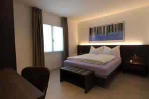 a hotel room with a bed and a window at LA MUELE Affittacamere in Gemona del Friuli