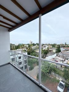 a balcony with a view of a city at The Altura Apartment in Mount Lavinia