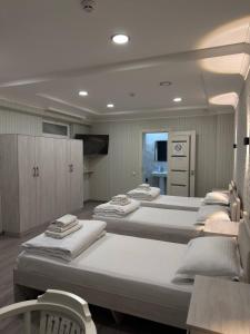 a room with a bunch of beds in it at Hotel Taht in Tashkent