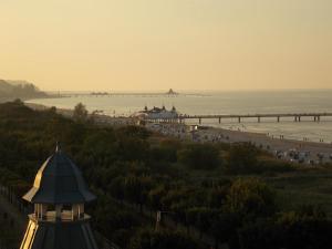 a view of a beach with a pier and a building at Ferienhaus Alessandra in Zinnowitz