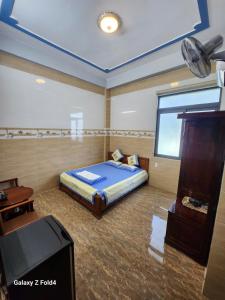 a bedroom with a bed and a tv in it at Van tan in Kon Plong