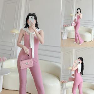 a woman wearing a pink jumpsuit and holding a pink purse at Van tan in Kon Plong