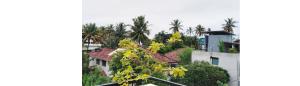 a view of a city with palm trees and buildings at Ariyana Sky Suites in Matara