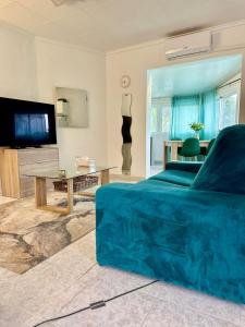 a living room with a bed and a flat screen tv at Peaceful Holiday Home with a Touch of Comfort in San Miguel de Salinas
