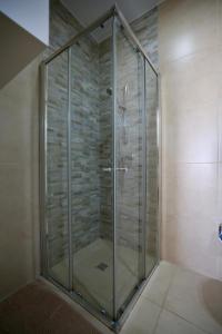 a shower with a glass door in a bathroom at Central 2 Bed Apartment in Gwardamanġa +25 photos
