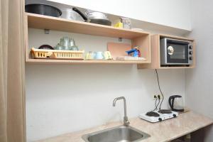 a kitchen counter with a sink and a microwave at C&H guest house in Yerevan