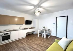 a kitchen and living room with a couch and a table at Residence Le Sirene in Termoli