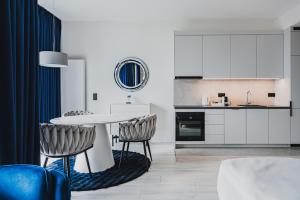 a kitchen and dining room with a table and chairs at Towarowa Towers SkyLine View in Warsaw +12 photos