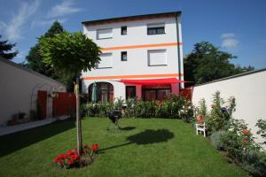 a large house with a yard with flowers and a lawn sidx sidx sidx at DAS Landhaus Klambauer - Apartmenthaus Thermennähe St Martins Therme in Frauenkirchen