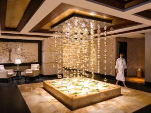 a woman standing in a room with a large bed at Sofitel Mumbai BKC in Mumbai +189 photos