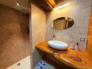 een badkamer met een wastafel en een spiegel bij Le Douillet des Pyrénées, Luxury Chalet Home in Ax-les-Thermes