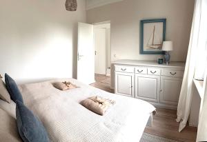 a bedroom with a bed with two pillows on it at Chiemsee Häuschen in Prien am Chiemsee