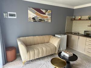 a living room with a couch and a table at UbuntuLifeStyleEstate-Premium Suite in Krugersdorp