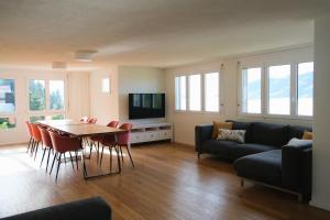 a living room with a couch and a table and chairs at Ferienhaus Mostelrain in Sattel