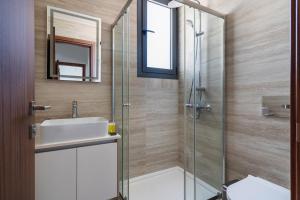 Pearl Beach Luxury Family Suite في ليماسول: حمام مع حوض ودش زجاجي +9 صور