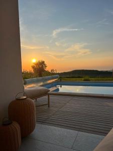 a view of a pool from a balcony with the sunset at The best view in Marezige