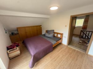 a bedroom with a bed with a purple blanket at Villa Helga Am Steinernem Meer in Saalfelden am Steinernen Meer