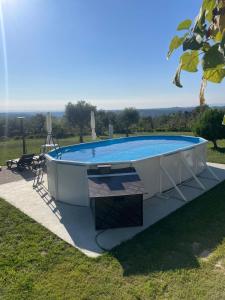 a pool in a yard with a view of a field at Quinta dos Covais AL in Tábua