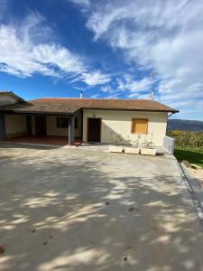 a house with a driveway in front of it at Bed and Breakfast "POGGIO MARANO" in San Bartolomeo in Galdo