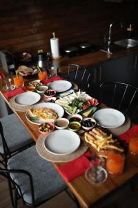 a wooden table with plates of food on it at Stay in Sapanca in Sapanca
