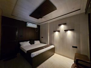 a bedroom with a bed with lights on the ceiling at Chhaya Niketan Home Stay in Ayodhya