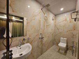 a bathroom with a sink and a toilet at Chhaya Niketan Home Stay in Ayodhya