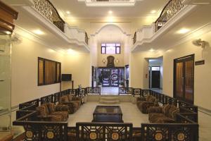 a hall with chairs and a table in a building at Le Grand Hotel in Haridwār
