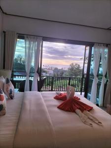 a bedroom with a large bed with a large window at Baan Seaview Sunset in Phra Ae beach +62 photos