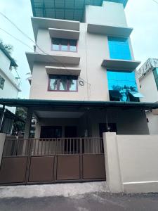 a house with a fence in front of it at Zarica Homestay in Kannur